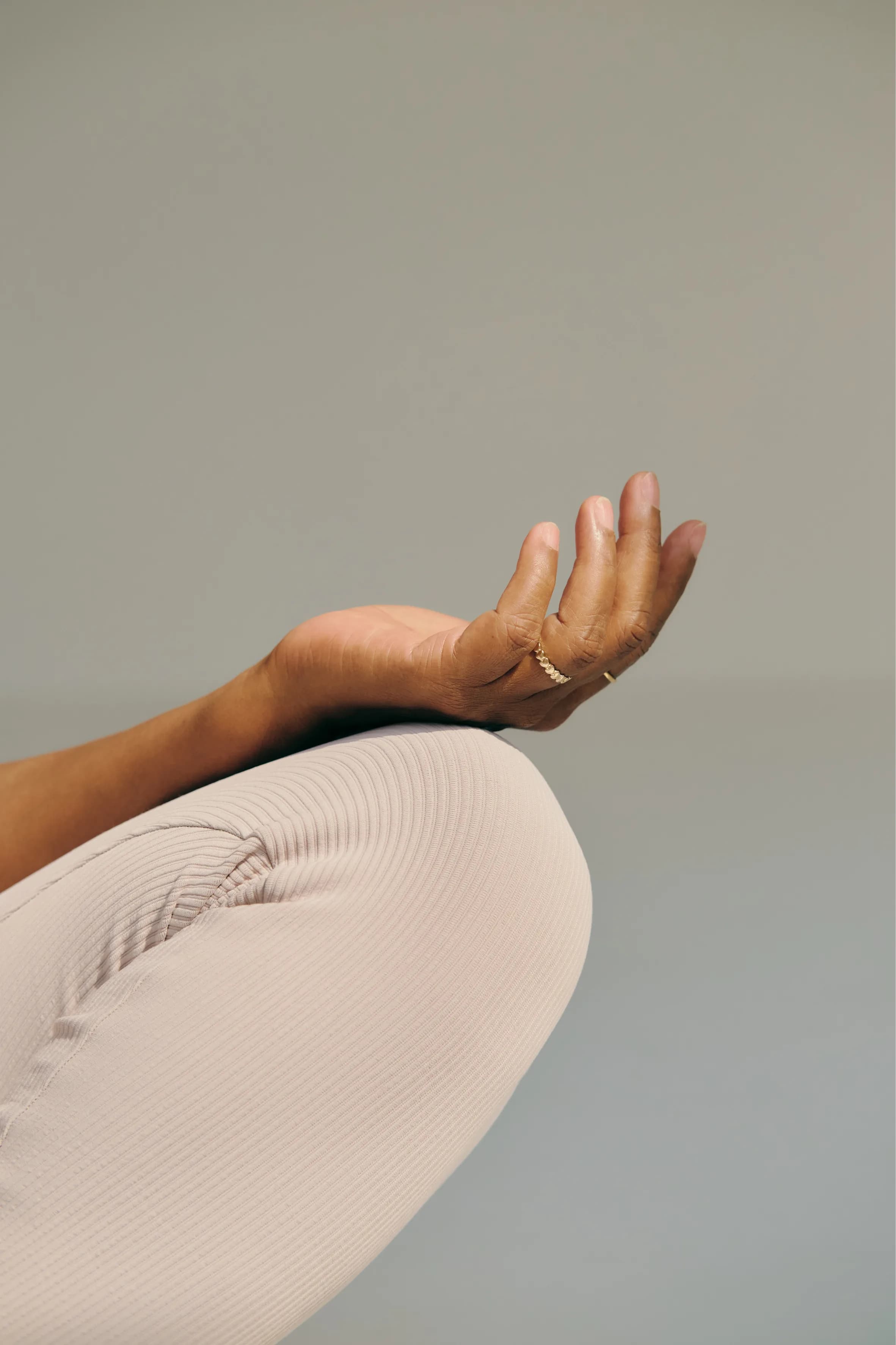 A person seated calmly with an open hand